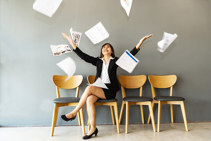 Woman celebrating throwing papers